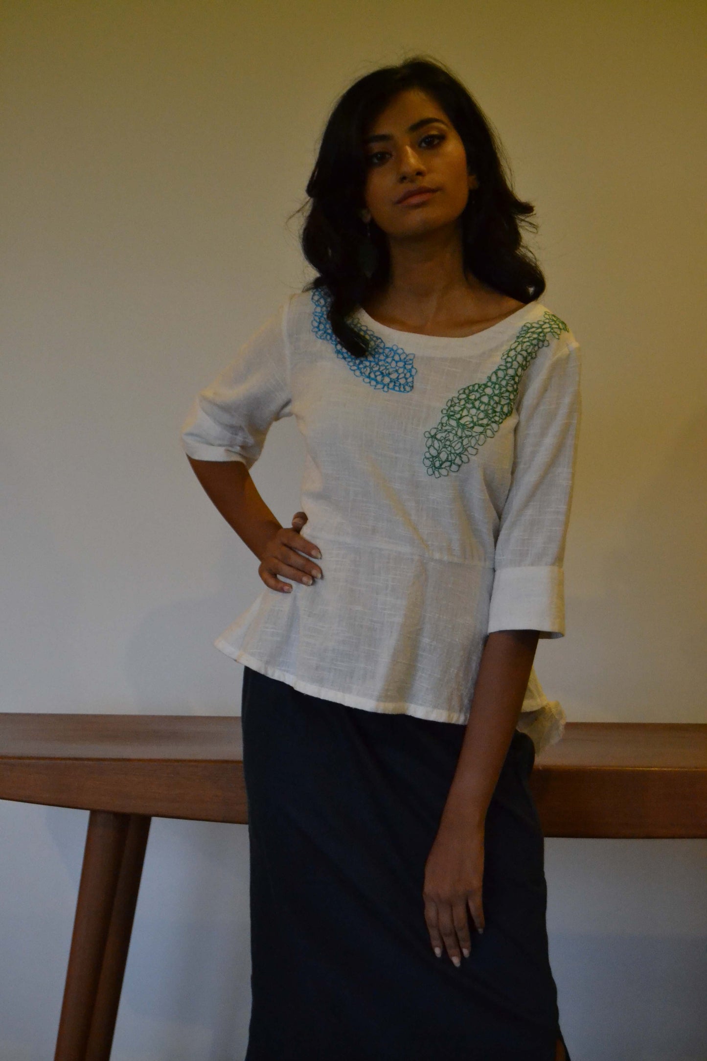 Peplum style tunic with loose thread embroidery and back button opening